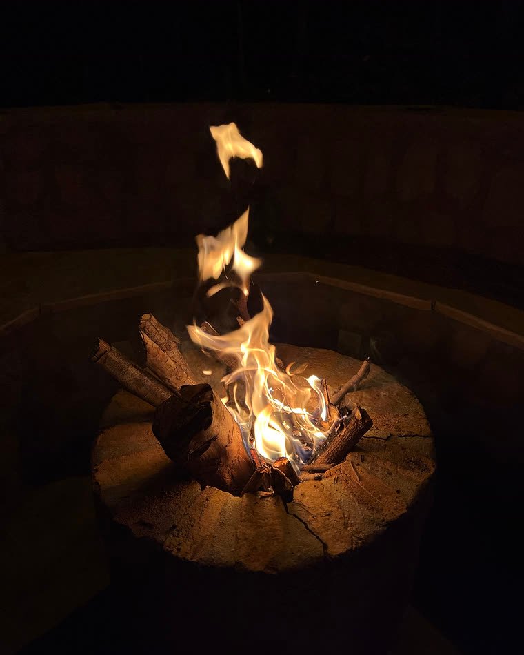 Fogueira acesa à noite na área externa dos chalés